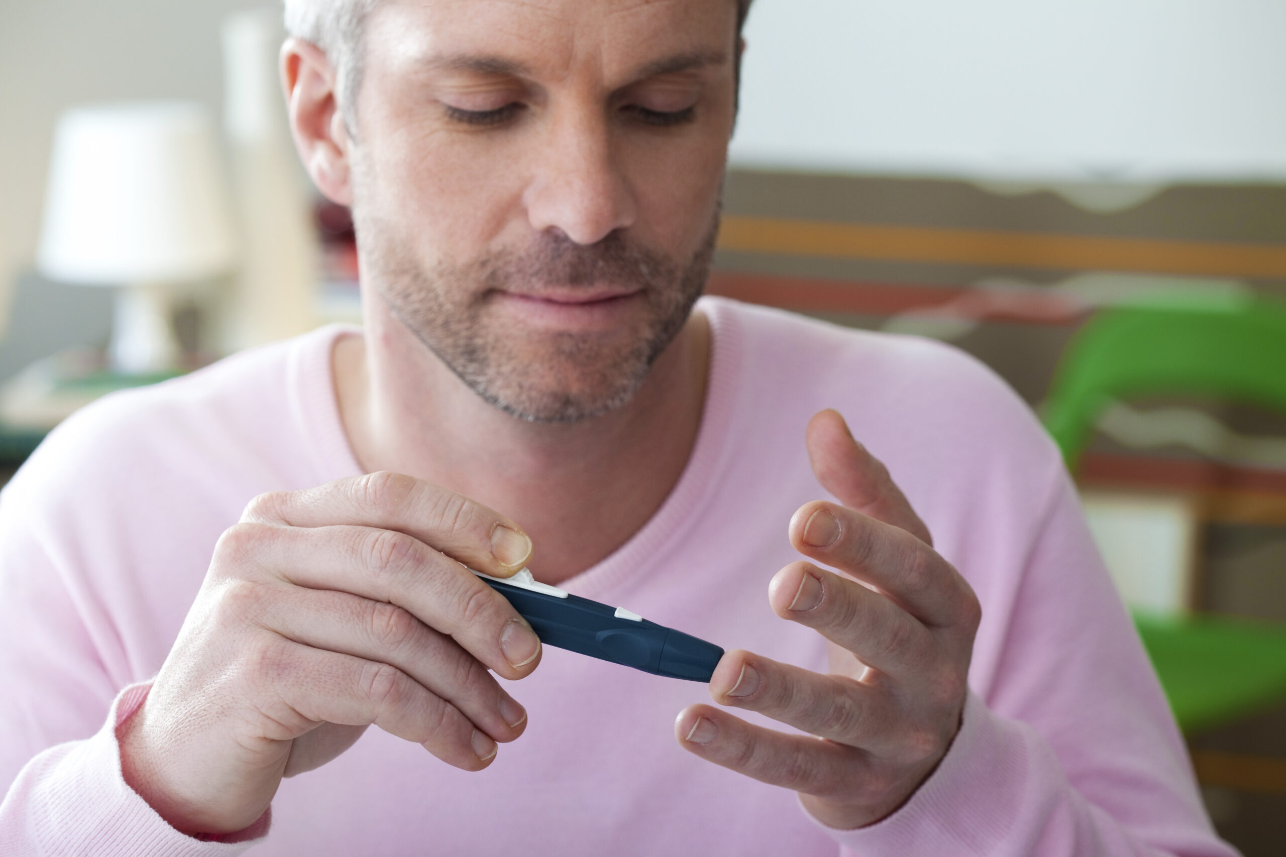 man doing his own diabetes blood test