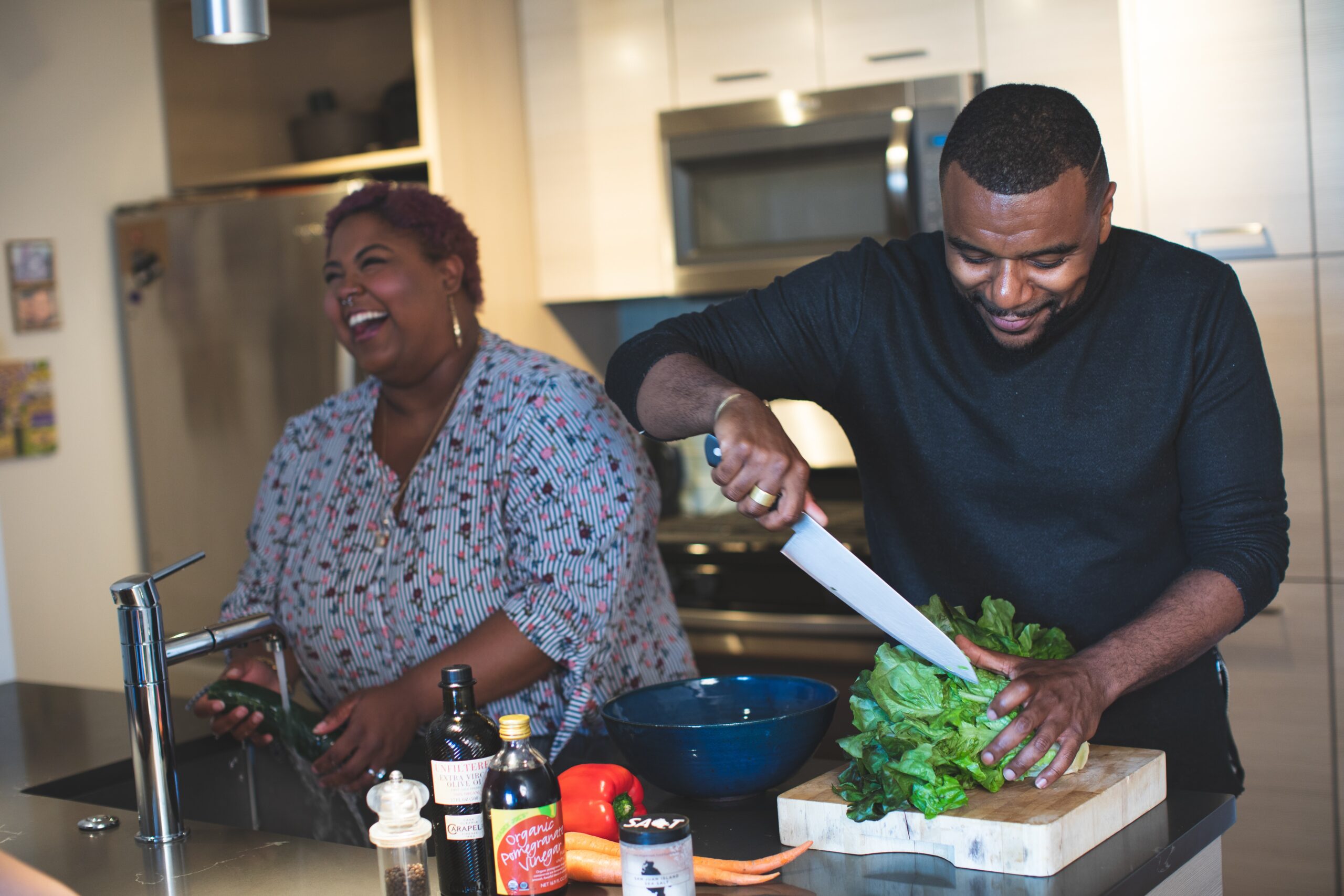 man and woman in kitchen cooking healthy food after a fast