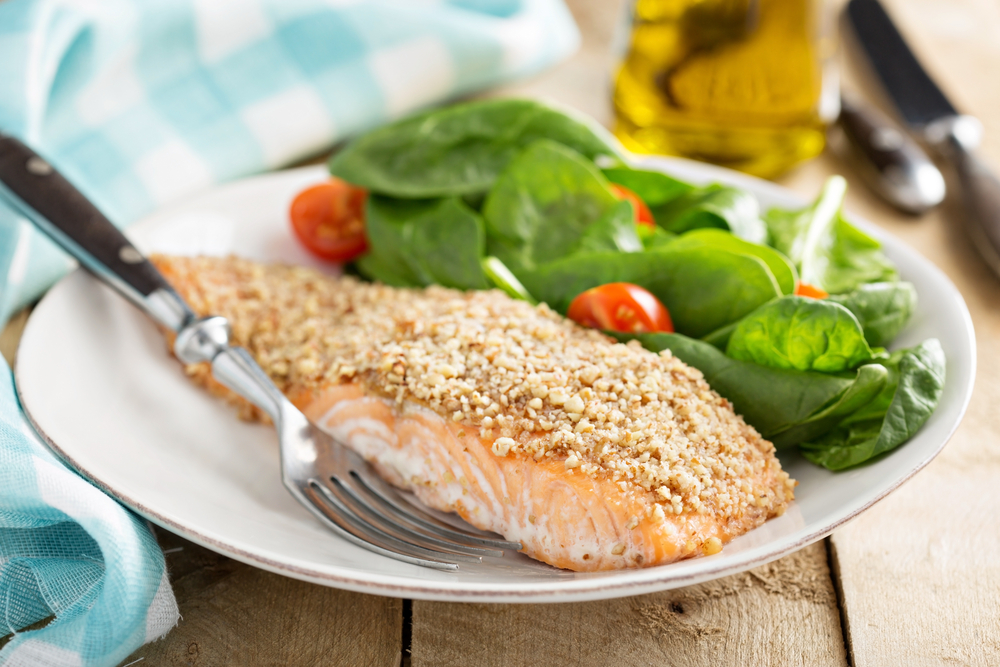 detox your body with food-Steamed cod fish fillet with broccoli, tomato, lemon, avocado, basil and pine nuts on a light background