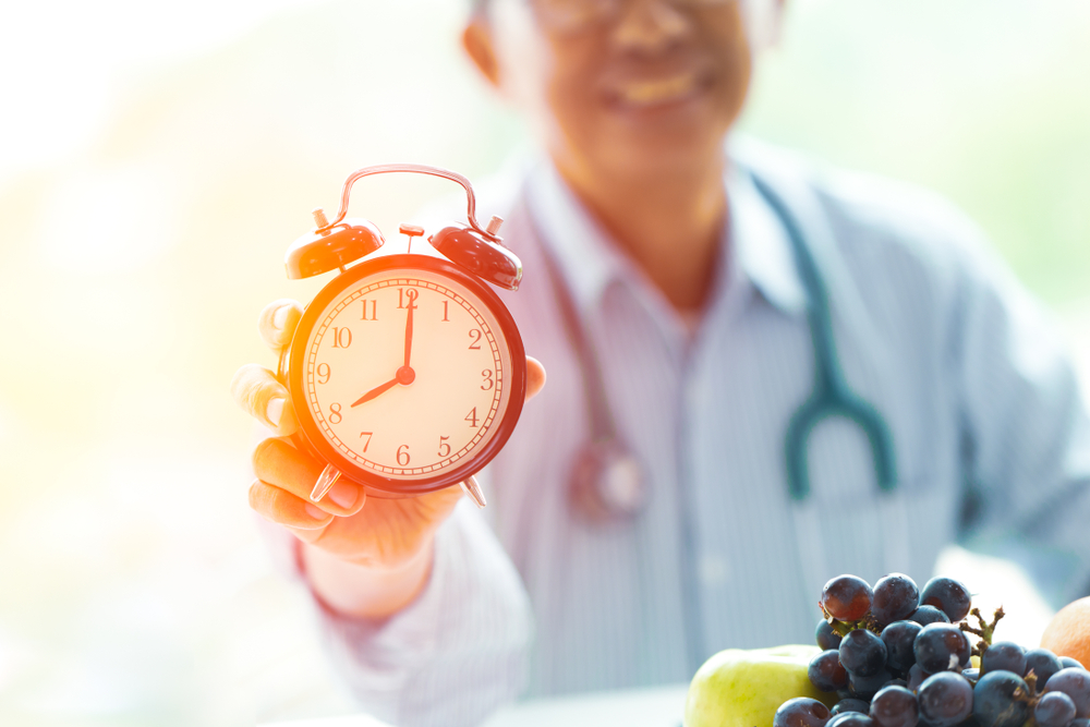 time for fasting image of doctor holding clock