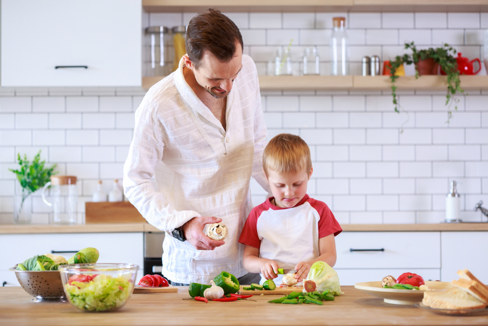 Family Meal Planning father son chopping vegetables