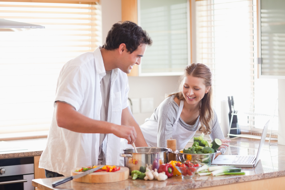 deciding which eating plan is best for you based on your goals, Young couple using the internet to look up recipe