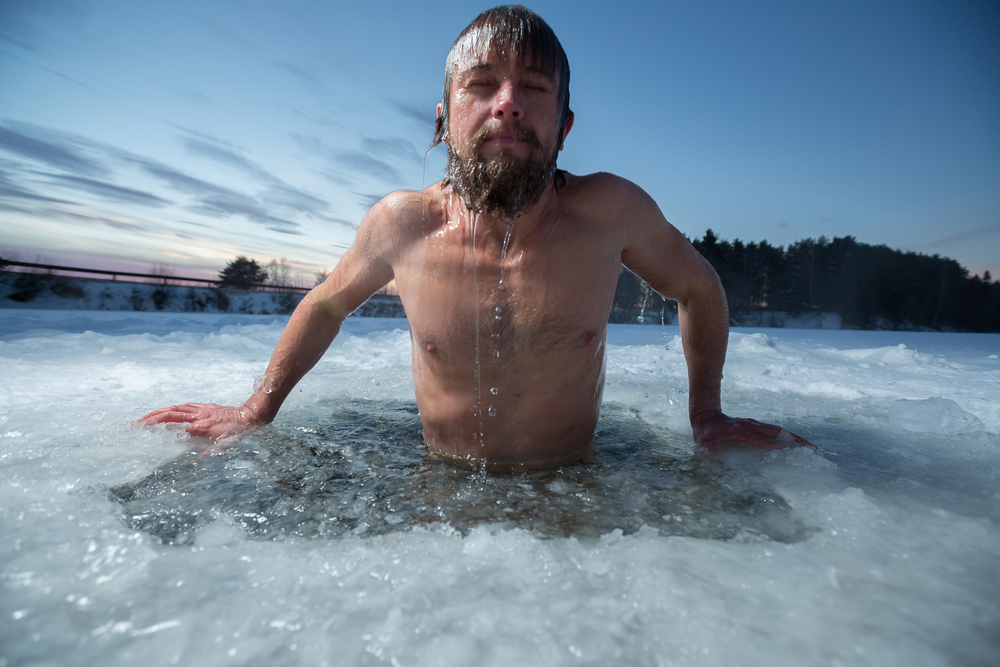 cold therapy Young man bathing in the ice hole